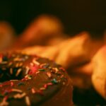 Food Aesthetics - Close-up of a chocolate donut with vibrant sprin #17399995