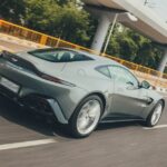 Luxury Cars - Sleek Aston Martin Vantage zooming on a highway #19986973