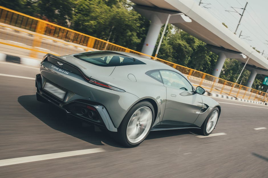 Luxury Cars - Sleek Aston Martin Vantage zooming on a highway #19986973