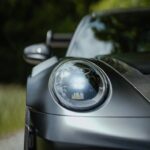 Luxury Cars - Close-up of a sleek sports car headlight in a fo #34285247