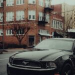 Luxury Cars - Modern black car parked on a rainy urban street #34998665