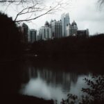 City Architecture - Moody city skyline with a lake reflection on an #35420320